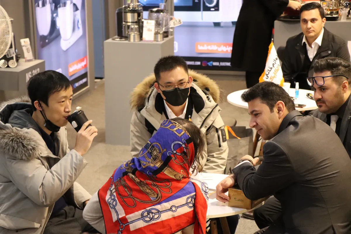 Tourists visiting the NASA Electric Company products exhibition in Iran, observing and reviewing household appliances and other products manufactured by the company.