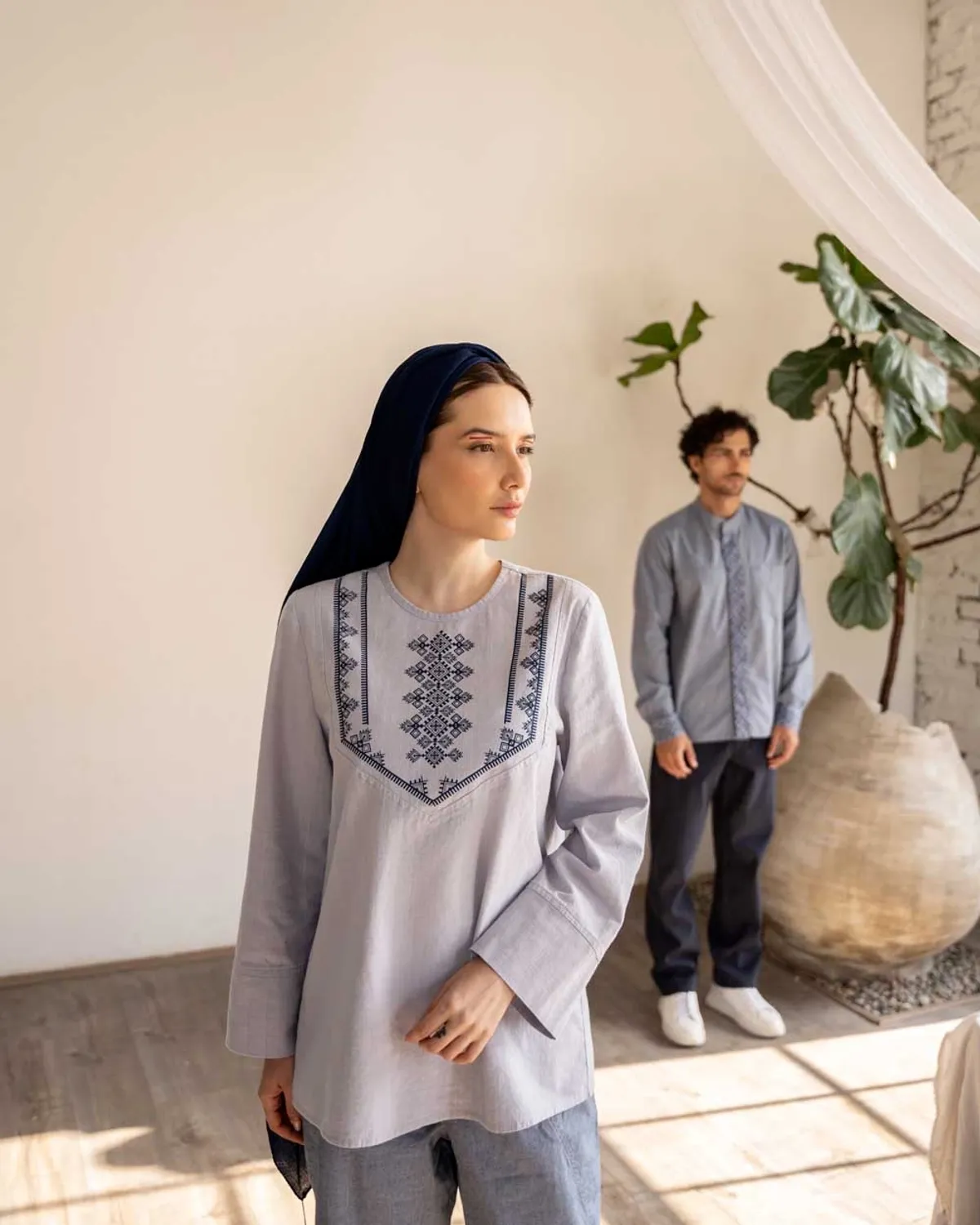 A man and a woman wearing Sunrise Tunics, standing and enjoying the morning moments.